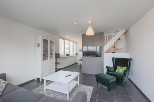 a living room with a couch and a table at Weststraat 22 - Ouddorp - Appartement Oost 3P in Ouddorp