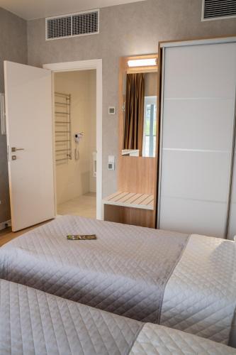 a bedroom with a large bed and a walk in shower at Green village Hotel in Mikolaivka