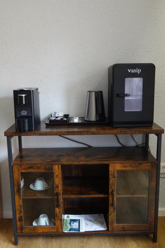 a wooden table with a microwave and a printer on it at Hotel Birnbaum in Ansbach