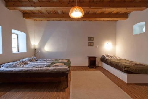 A bed or beds in a room at Karádi-Berger Vendégház