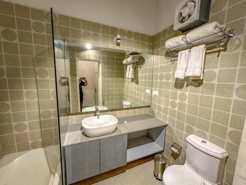 a bathroom with a sink and a toilet at DYORE House by Bharat Mahal Palace in Jaipur