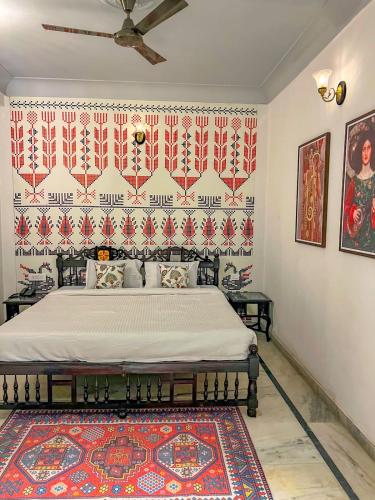 a bedroom with a bed in a room with a rug at DYORE House by Bharat Mahal Palace in Jaipur