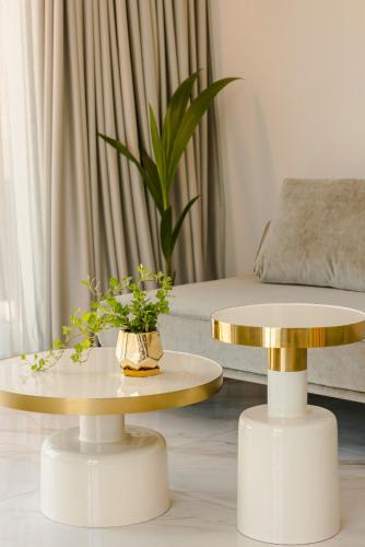 a living room with two tables and a couch at G Boutique Hotel Kefalonia in Argostoli