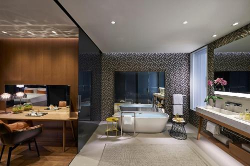 a bathroom with a tub and a sink at Mandarin Oriental, Barcelona in Barcelona