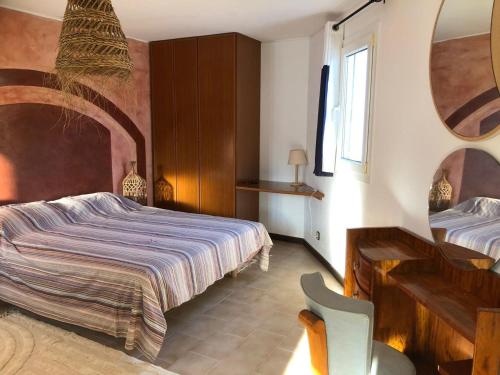 a bedroom with a bed and a desk and a chair at Charming Villa Son Parc in Son Parc
