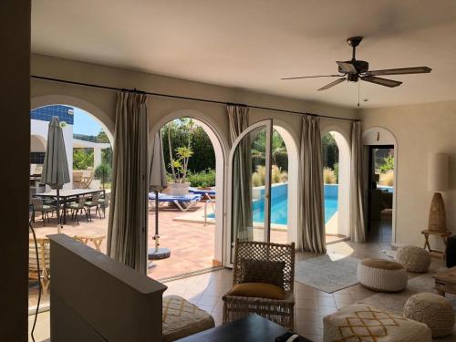 a living room with a view of a pool at Charming Villa Son Parc in Son Parc