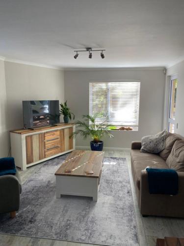 a living room with a couch and a coffee table at Hack's Shack in Cape Town