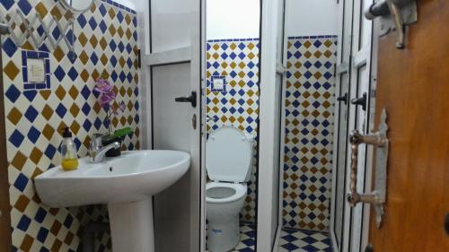 a bathroom with a sink and a toilet at hostel four seasons in Tetouan