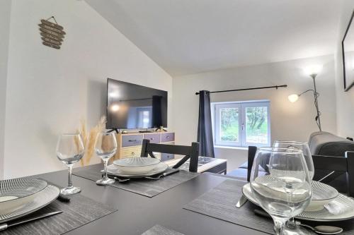 a dining room with a table with wine glasses at Le St Clair 401 - Luxury equipped apartment - Caluire-et-Cuire in Caluire-et-Cuire
