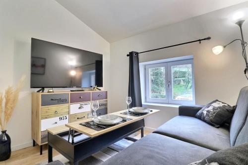 a living room with a couch and a table at Le St Clair 401 - Luxury equipped apartment - Caluire-et-Cuire in Caluire-et-Cuire