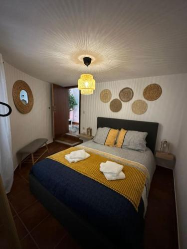 a bedroom with a bed with two towels on it at casa dos Ferreira no Douro in Ucanha