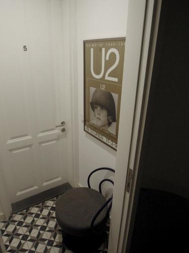a room with a toilet and a poster on the wall at Kumbaracı Apartments & Suites in Istanbul