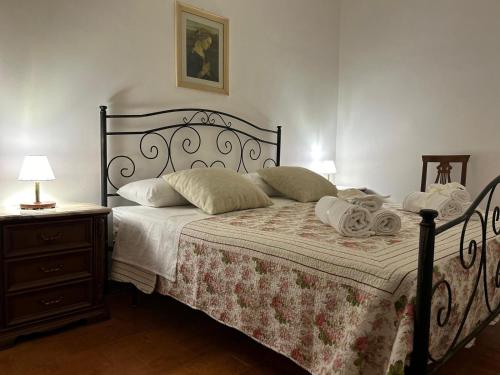 a bedroom with a bed with a blanket and a nightstand at Relais La Villa in Lucera