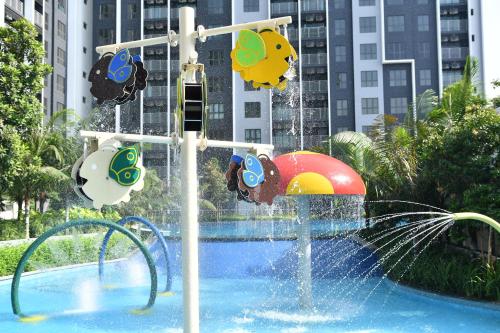 a water park with a water slide in a pool at Maya Bay Residences Gamuda Cove SplashMania in Pulau Kempas