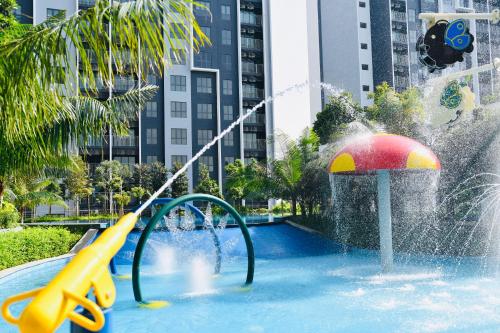 a pool with a water slide in a city at Maya Bay Residences Gamuda Cove SplashMania in Pulau Kempas