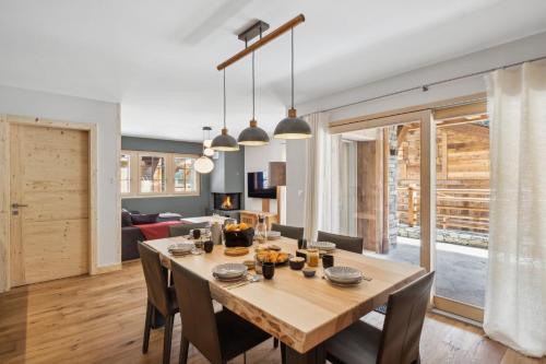 a dining room and living room with a table and chairs at Chalet Larchwood by Mrs Miggins in Grimentz