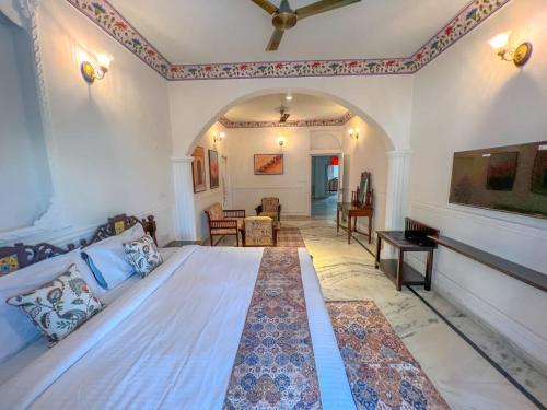 a bedroom with a large bed and a living room at DYORE House by Bharat Mahal Palace in Jaipur