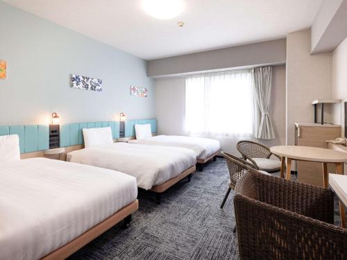 Postel nebo postele na pokoji v ubytování Comfort Hotel Naha Prefectural Office