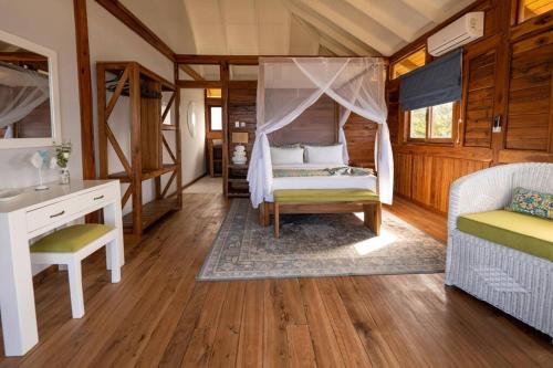 a bedroom with a bed and a desk in a room at Aloha 19 in Ponta Mamoli
