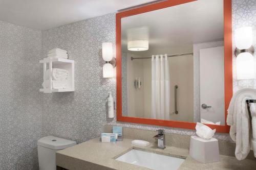 a bathroom with a sink and a mirror and a toilet at Hampton Inn Northwood in Myrtle Beach