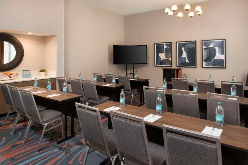 a conference room with tables and chairs and water bottles at Hampton Inn Northwood in Myrtle Beach