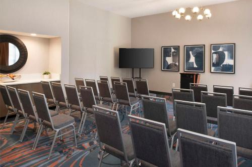 a conference room with chairs and a flat screen tv at Hampton Inn Northwood in Myrtle Beach