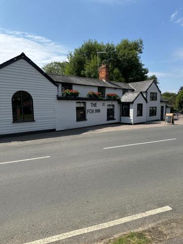 a white building on the side of a street at The Fox Inn in Matching