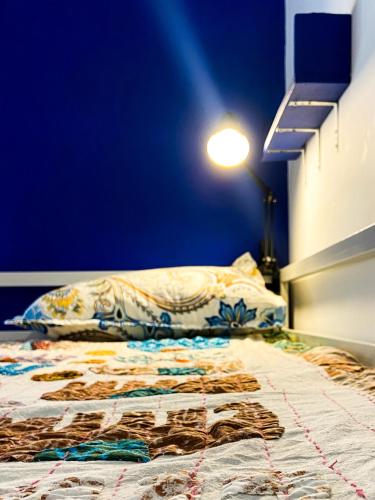 a bed in a room with a blue wall at Comfort & Cozy, Villa in Orchha
