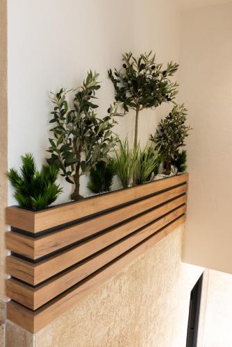 a wooden planter with plants on a wall at Apartmani Skadarlija Valjevo in Valjevo