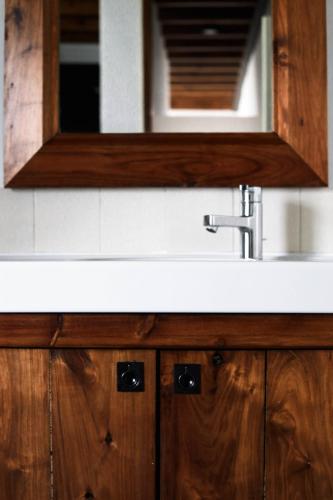 a bathroom sink with a mirror above it at Casa de Almagreira - Empreendimento de Turismo em Espaço Rural - Casa de Campo in Vila do Porto