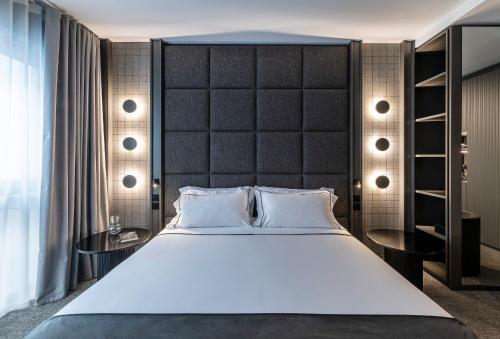a bedroom with a large bed and two tables at Zeta Rentals in Bari
