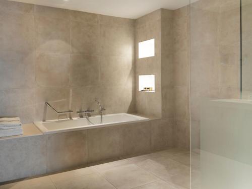 a bathroom with a sink and a bath tub at Van Der Valk Hotel Zwolle in Zwolle