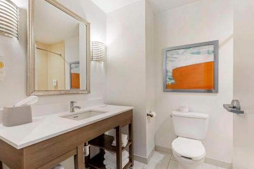 a bathroom with a sink and a toilet and a mirror at Comfort Inn & Suites Chestertown in Chestertown