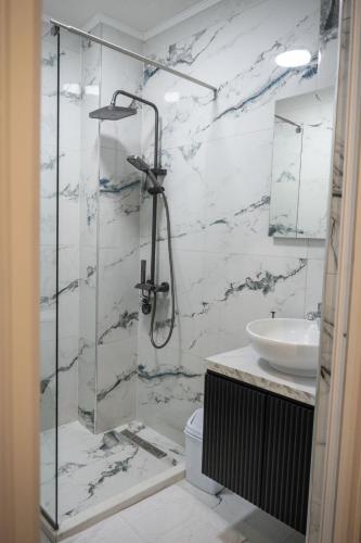a bathroom with a shower and a sink at Hotel CENTRAL in Prilep