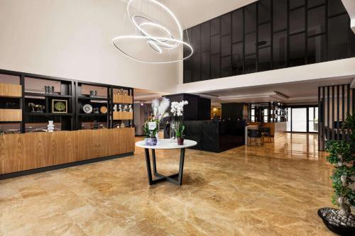 a lobby with a table with flowers on it at Days Inn by Wyndham Istanbul Arnavutkoy in Istanbul