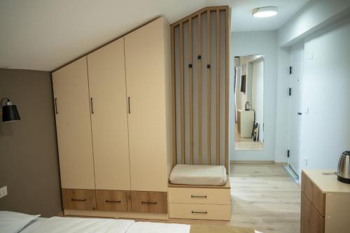 a bedroom with a closet with a chair in it at Hotel CENTRAL in Prilep