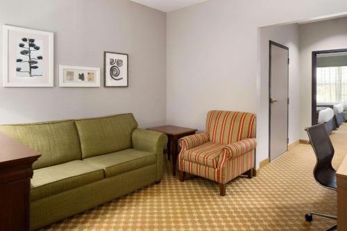 a living room with a couch and a chair at Country Inn & Suites by Radisson, Gettysburg, PA in Gettysburg