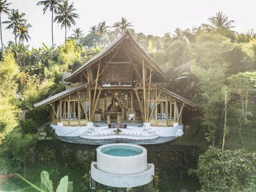 a house with a pool in front of it at Magic Hills Bali - Eco Luxury Adventure in Karangasem