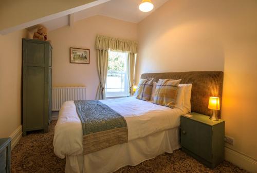 a bedroom with a large bed and a window at Picton-House in St Clears