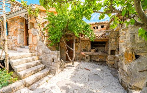 an old stone building with stairs and a tree at 1 Bedroom Pet Friendly Home In Poljica in Poljica
