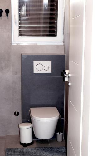 a small bathroom with a toilet and a window at Apartment Lavander in Novalja