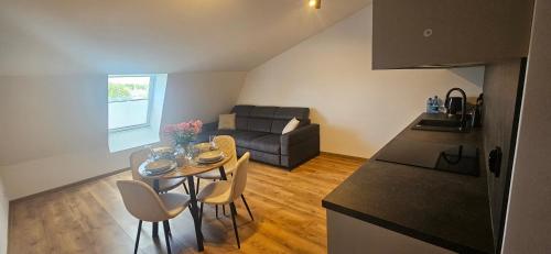 a kitchen and a living room with a table and chairs at Arkady House in Olsztynek