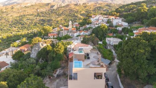 an aerial view of a town with a mountain at Luxury apartment with rooftop pool in Meronas in Méronas