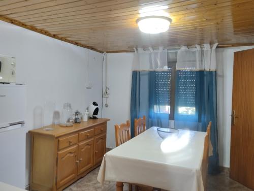 a dining room with a white table and chairs at Casa de Valeria in Tomiño