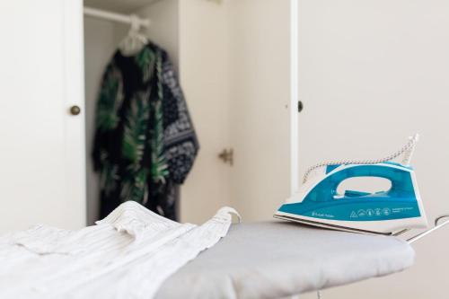 a blue bag sitting on top of a bed at Artemis Cynthia Complex in Paphos City