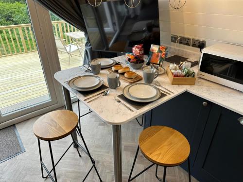 a table with plates of food on it in a kitchen at Byrnside Lodge in Latheron