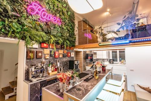 a bar in a restaurant with plants on the wall at Luxe & Central Haven - Jacuzzi, Sauna, Steam, Private Parking in Como