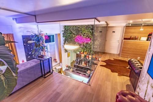 a living room with a couch and a glass wall at Luxe & Central Haven - Jacuzzi, Sauna, Steam, Private Parking in Como