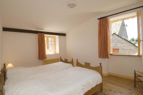a bedroom with a white bed and a window at Village de gîtes de Sainte-Lucie in Sainte-Lucie