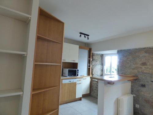a kitchen with white cabinets and a counter top at Village de gîtes de Sainte-Lucie in Sainte-Lucie